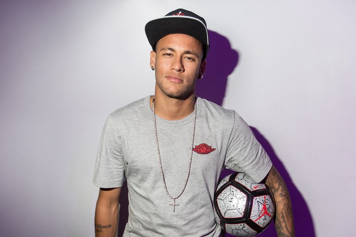 Neymar Jr holding a soccer ball