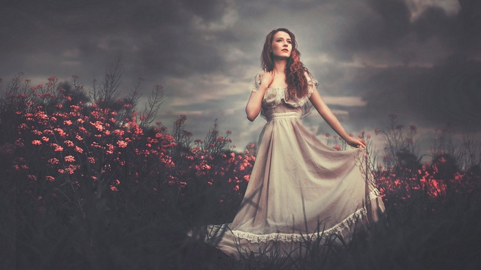 Woman in a flowing dress in a field of flowers
