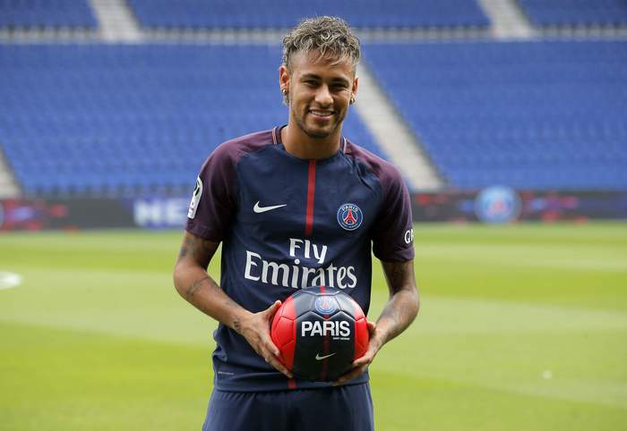 Neymar Jr. holding a soccer ball