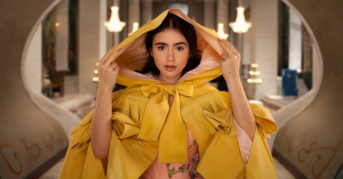 Lily Collins in a yellow hooded cape