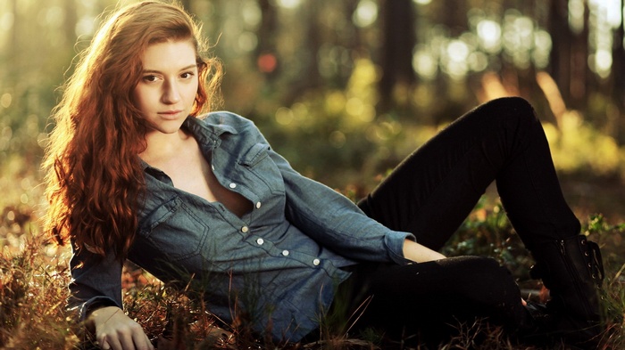 Woman with red hair in a forest