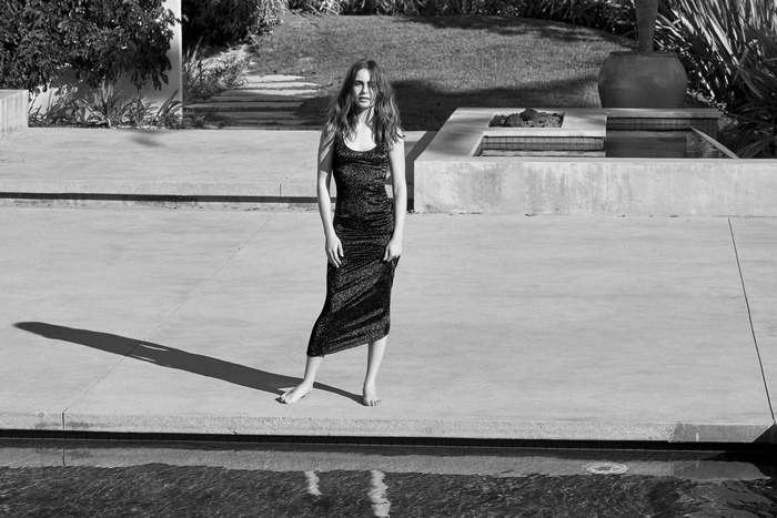 Lily Collins in a sparkly dress by a pool
