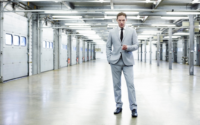 Man in a suit in a warehouse