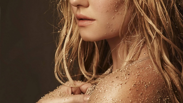 Woman covered in sand with blonde hair