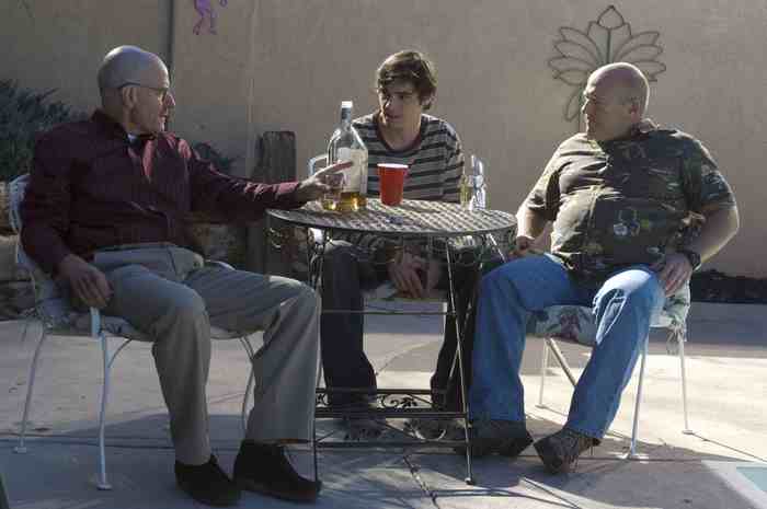 Bryan Cranston and two men at a table