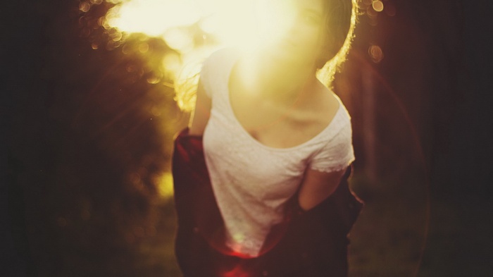 Woman in white shirt with sun flare