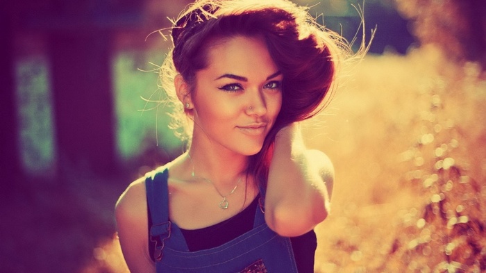 Woman with hair up wearing overalls