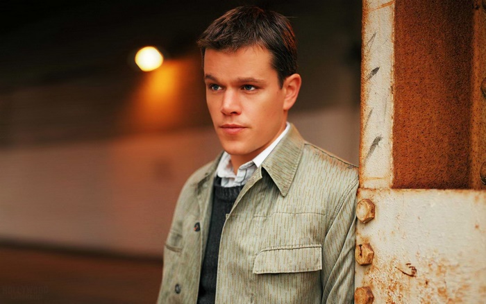 Matt Damon leaning on a rusty pillar