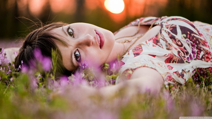 Woman lying in a field of flowers