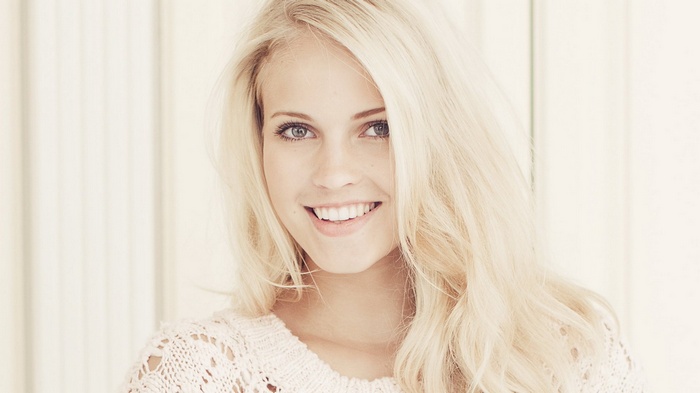 Young woman with blonde hair smiling