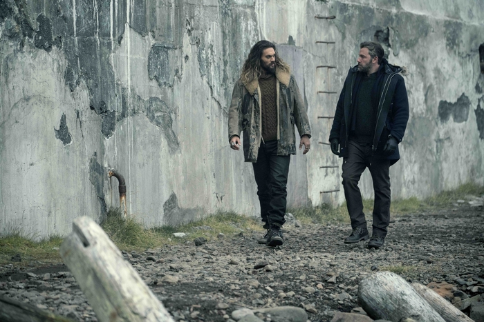 Jason Momoa and Ben Affleck walking by a concrete wall