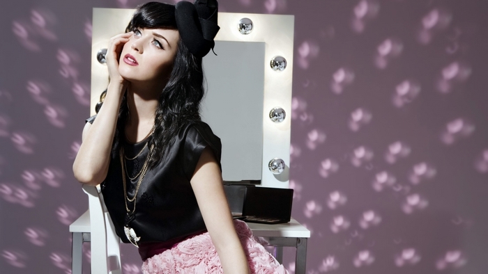 Katy Perry in front of a lighted mirror