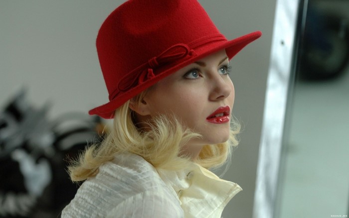 Elisha Cuthbert wearing a red hat