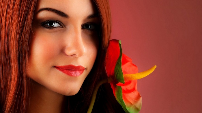Woman with red hair and a red flower