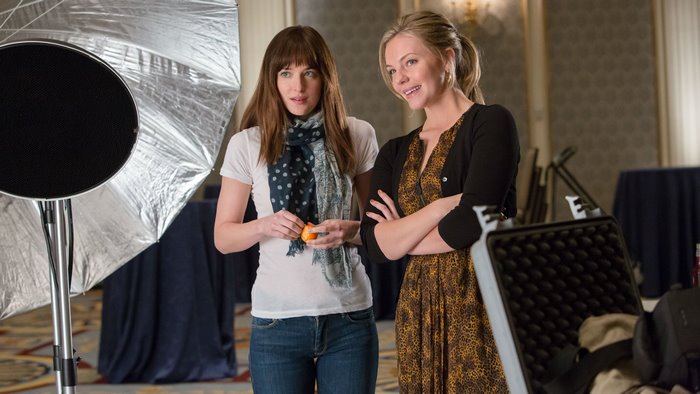 Dakota Johnson and woman with camera equipment