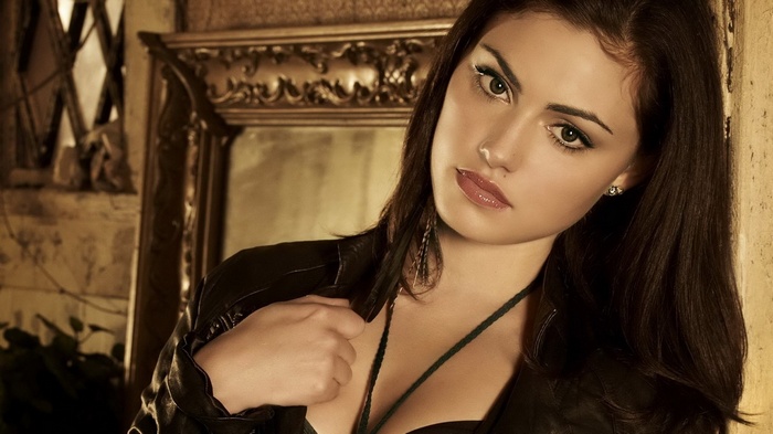 Woman in black leather jacket with ornate mirror