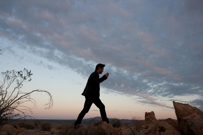 Colin Farrell walking in desert landscape