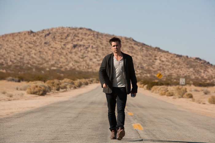 Colin Farrell walking on a desert road