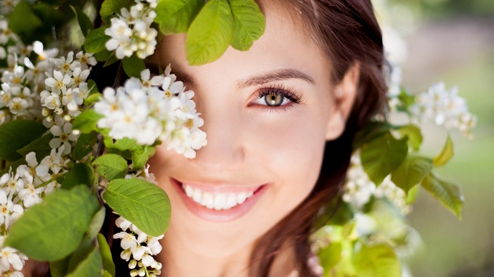 Woman with white flowers and green leaves