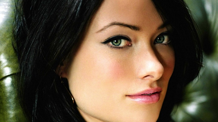 Close-up of a woman's face with green eyes