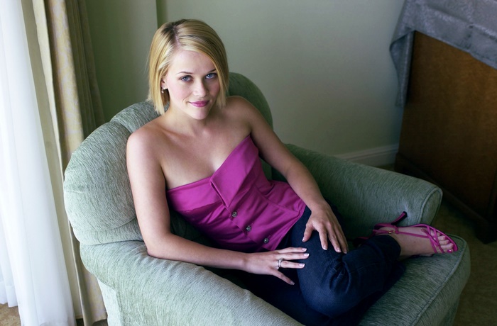 Reese Witherspoon sitting in a chair