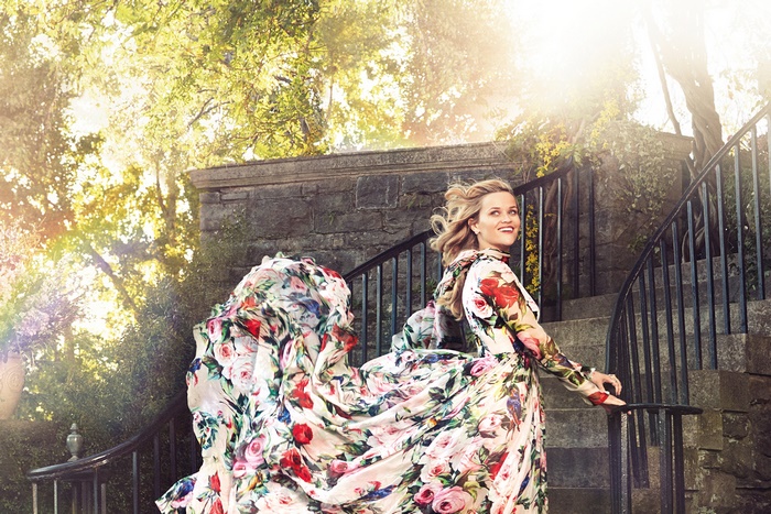 Reese Witherspoon in a floral dress on stairs
