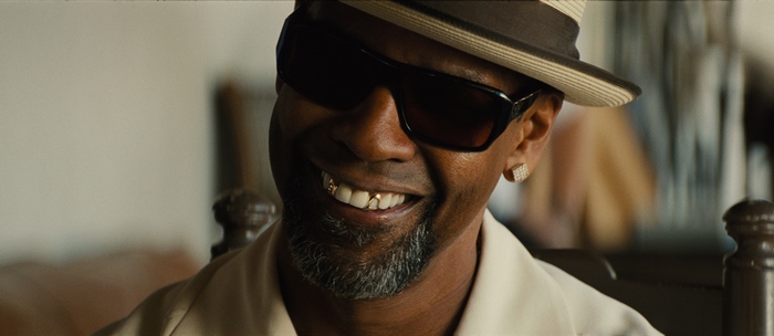 Denzel Washington wearing sunglasses and a hat