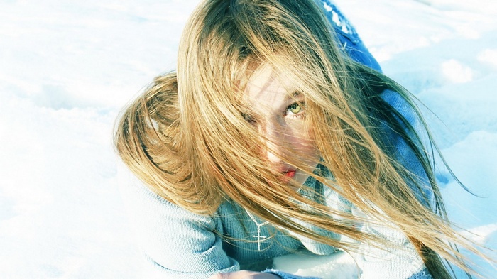 Girl with blonde hair in the snow