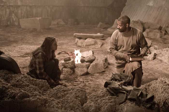 Denzel Washington and young girl by campfire