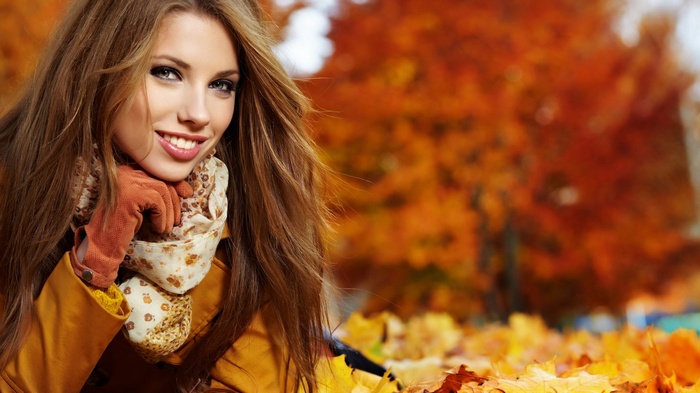 Woman in autumn park with fall foliage