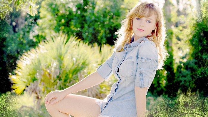 Young woman in denim shirt outdoors