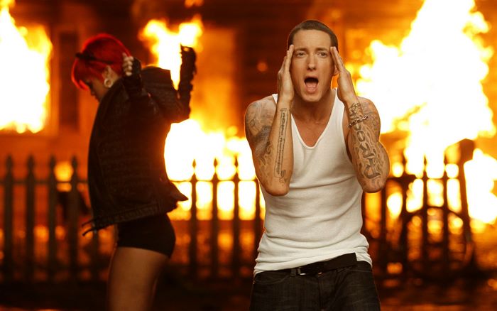 Eminem and Rihanna in front of a burning house