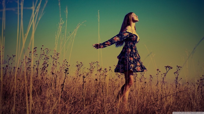 Woman in floral dress in a field