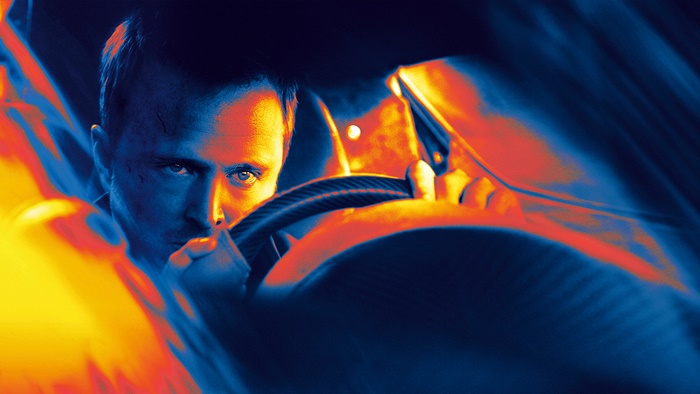 Aaron Paul driving a car