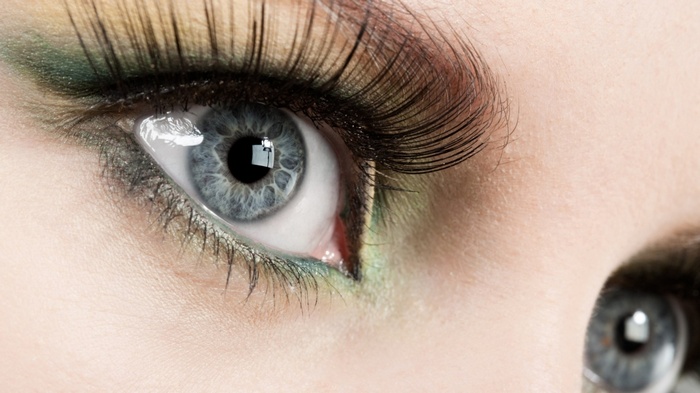 Close-up of a woman's blue eye with makeup
