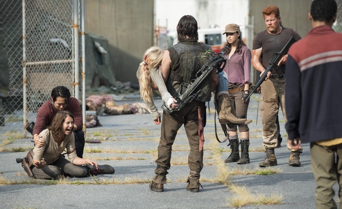 The Walking Dead characters carrying an injured woman