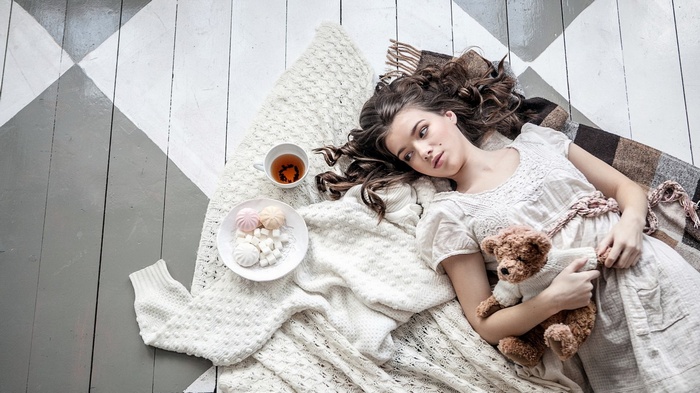 Girl with teddy bear and tea
