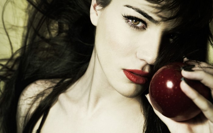 Monica Bellucci holding a red apple