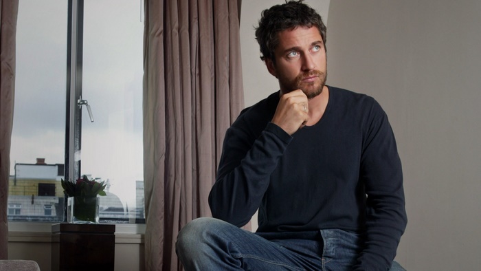 Gerard Butler sitting by the window