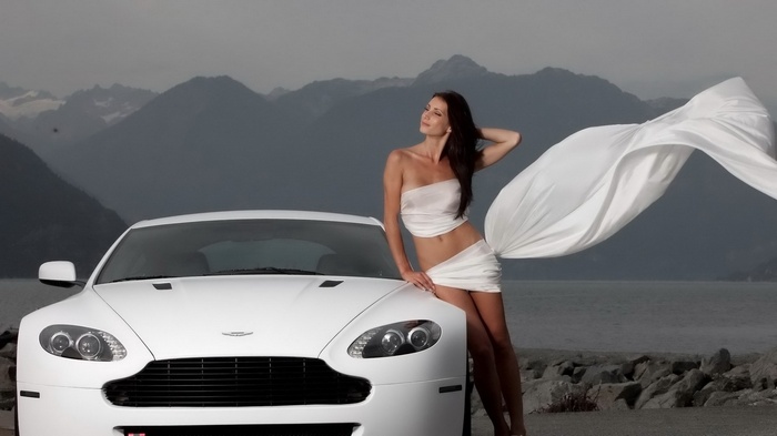 Woman in white fabric with white Aston Martin