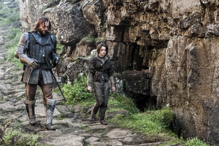The Hound and Arya Stark walking on a rocky path