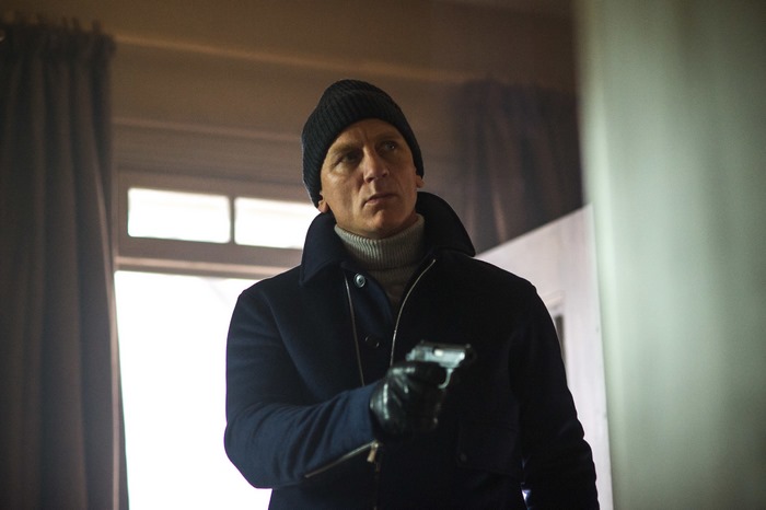 Daniel Craig as James Bond holding a pistol