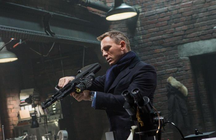Daniel Craig holding a futuristic rifle