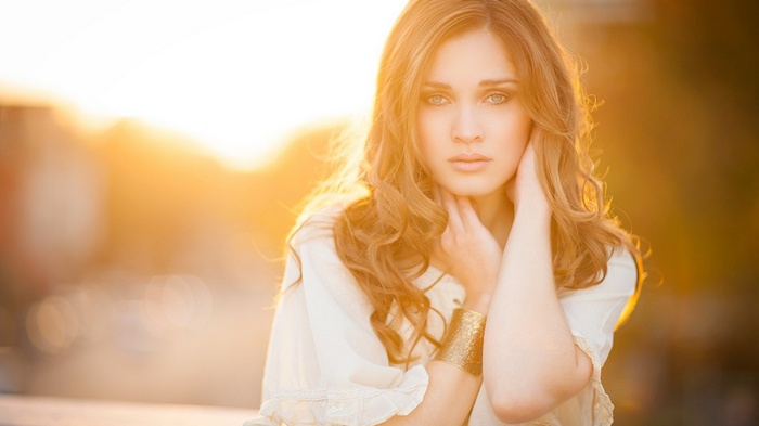 Woman with long wavy hair in golden hour light