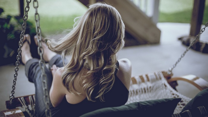 Woman on a porch swing