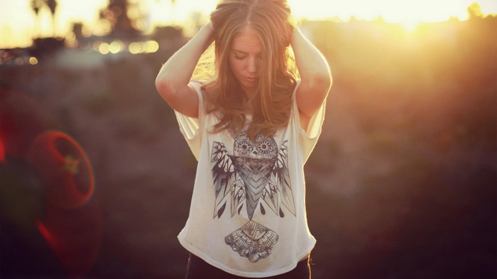 Woman with owl shirt at sunset