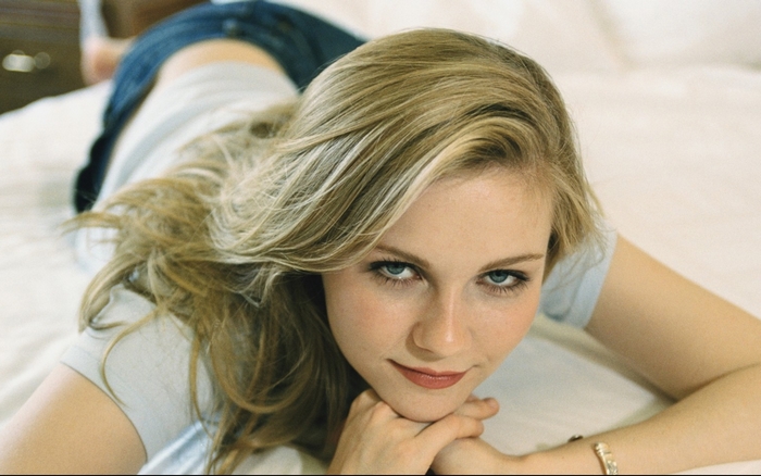 Kirsten Dunst lying on a bed