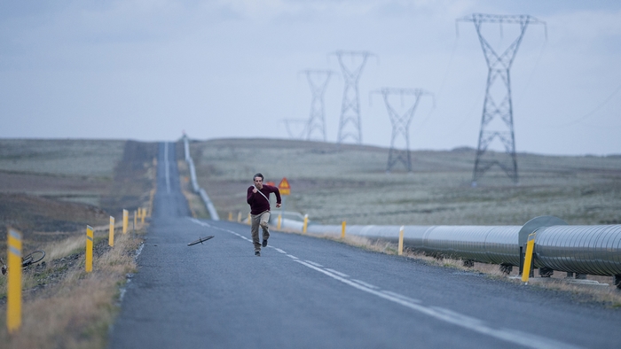 Ben Stiller running on a road in Iceland