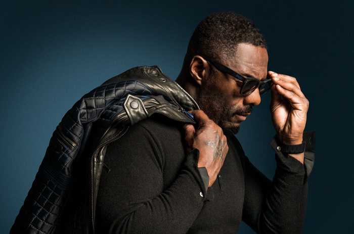 Idris Elba wearing glasses and jacket