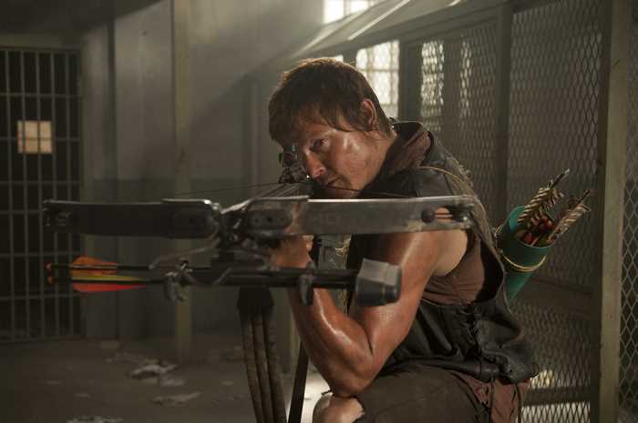 Norman Reedus with crossbow in prison